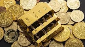 Gold bars and coins representing the rise in gold prices